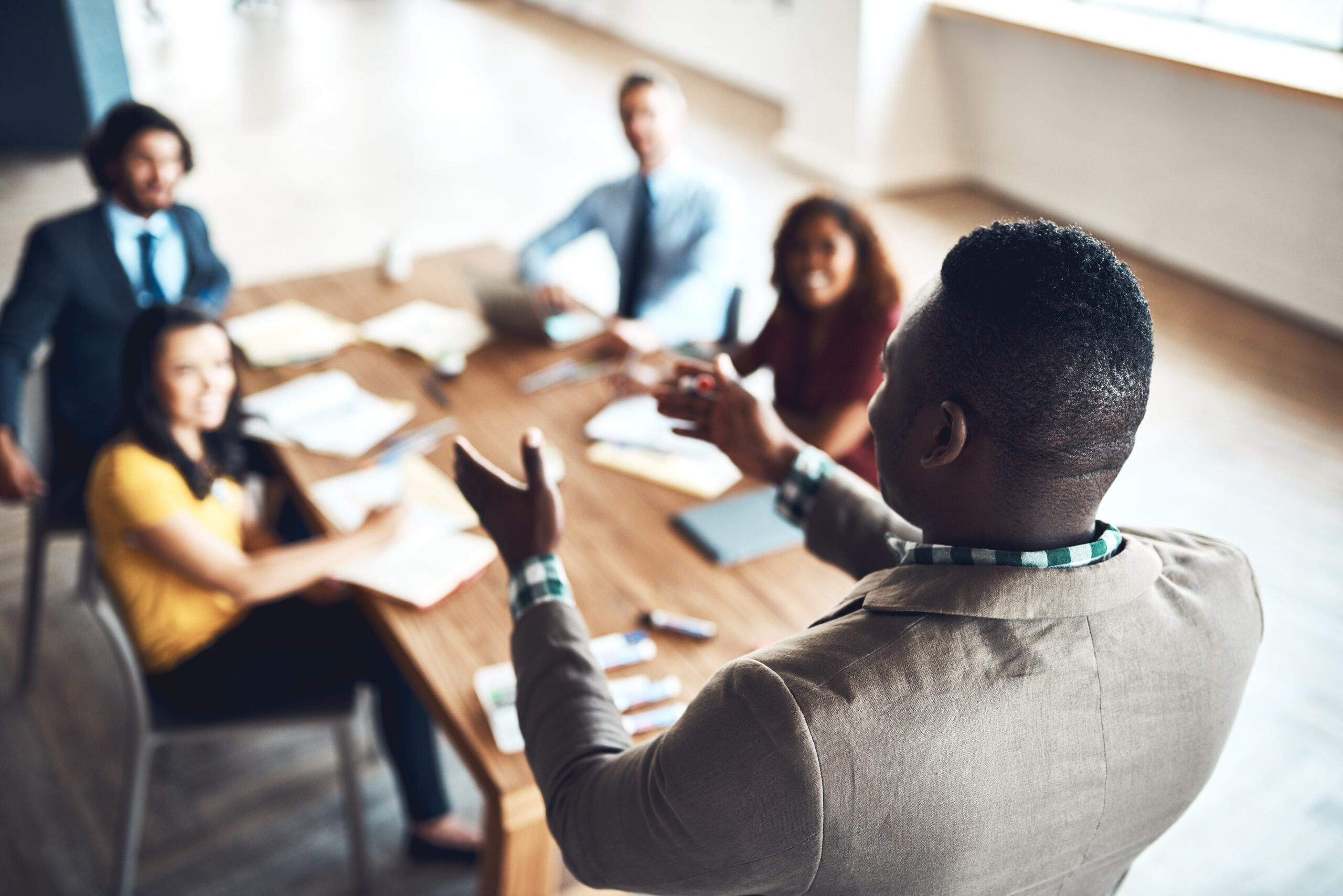 Business leader addressing a team during a corporate meeting about leadership, accountability, and workplace trust.